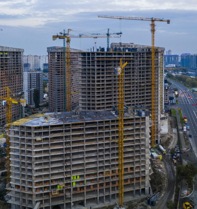 Construction site with cranes at sunset. Construction of an apartment building